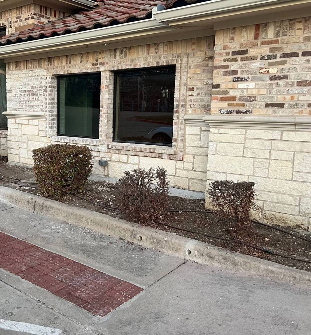 Repaired corner with matched brick, stone and new windows