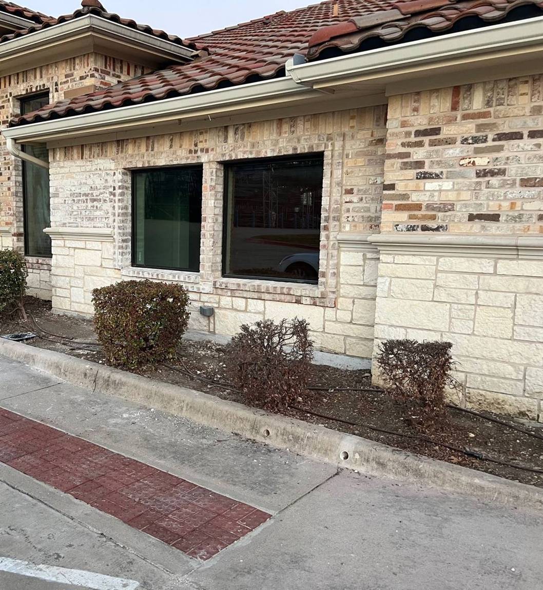Finished exterior with matched brick, cast stone trim and new plate-glass windows