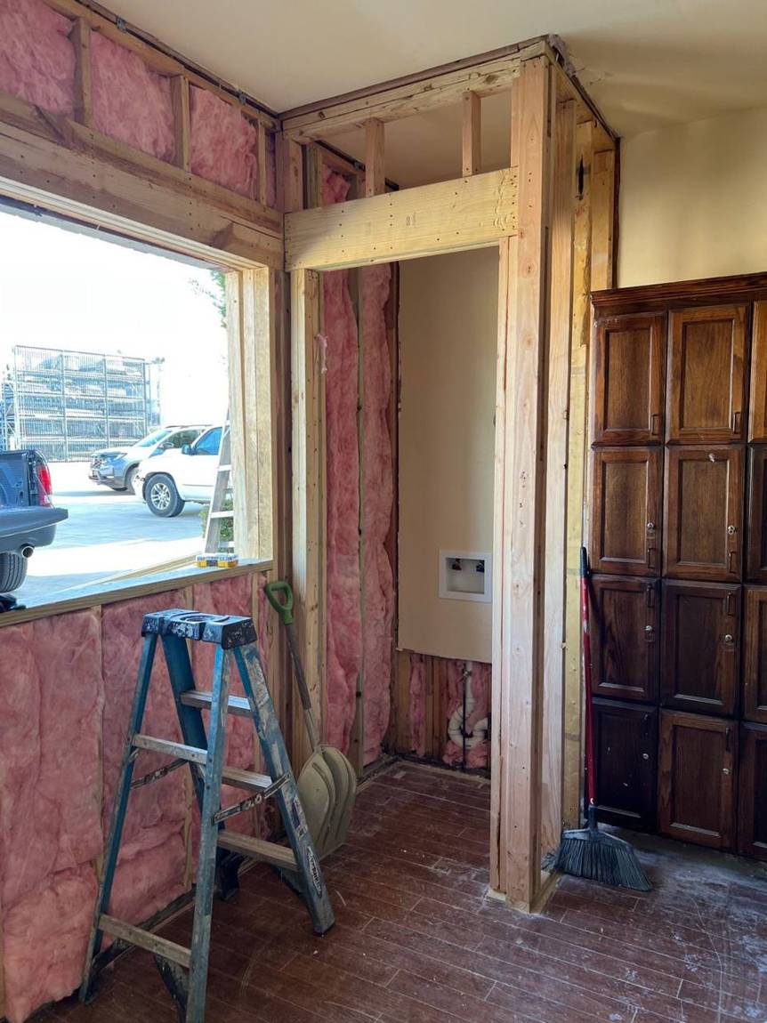 New framing, insulation and laundry hookups inside the rebuilt wall