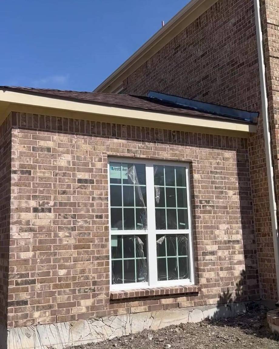 Front face of the addition with matching brick and a double window