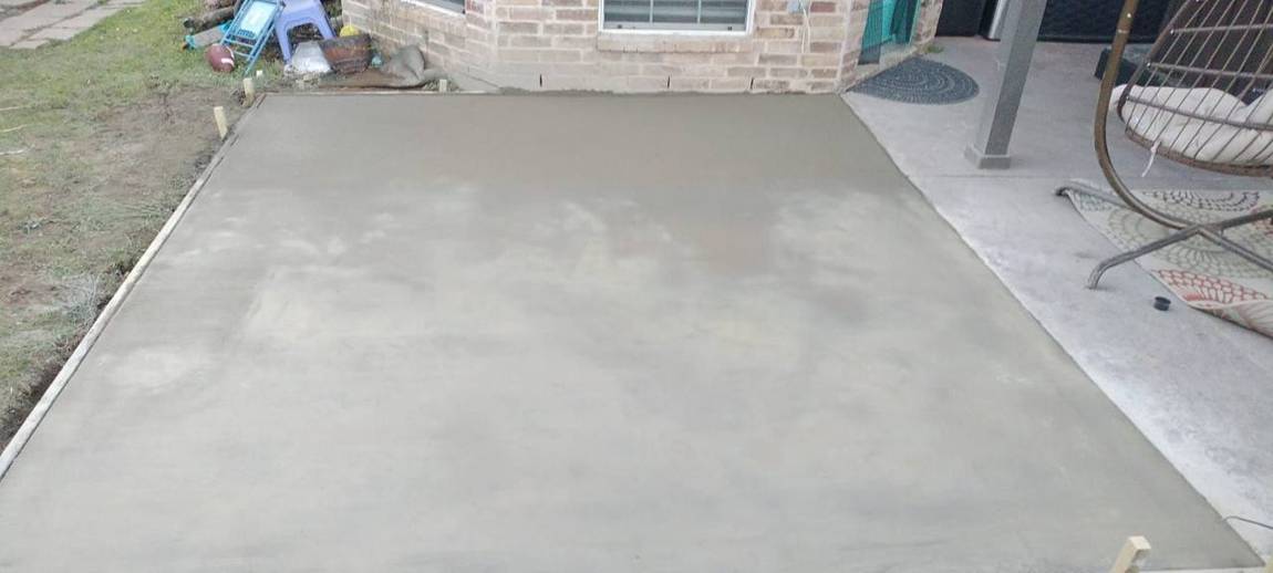 Finished smooth concrete pad next to the existing patio