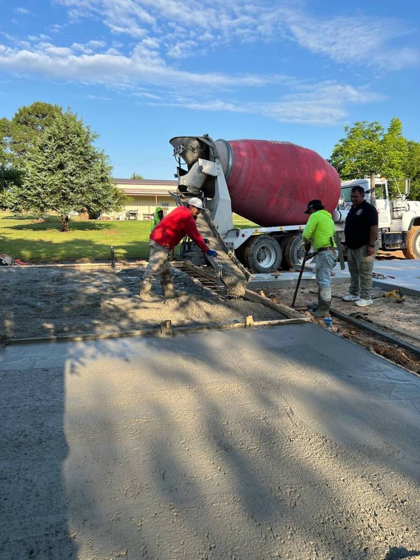 Crew pouring concrete from the mixer chute