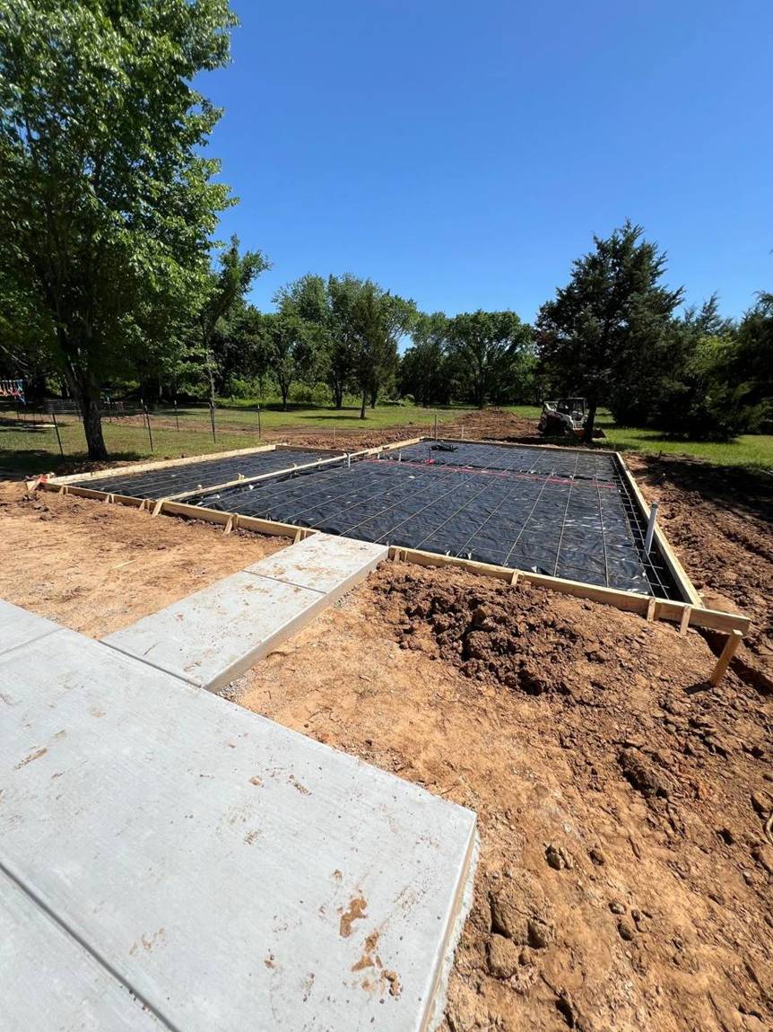 Pool house slab formed with vapor barrier and rebar grid