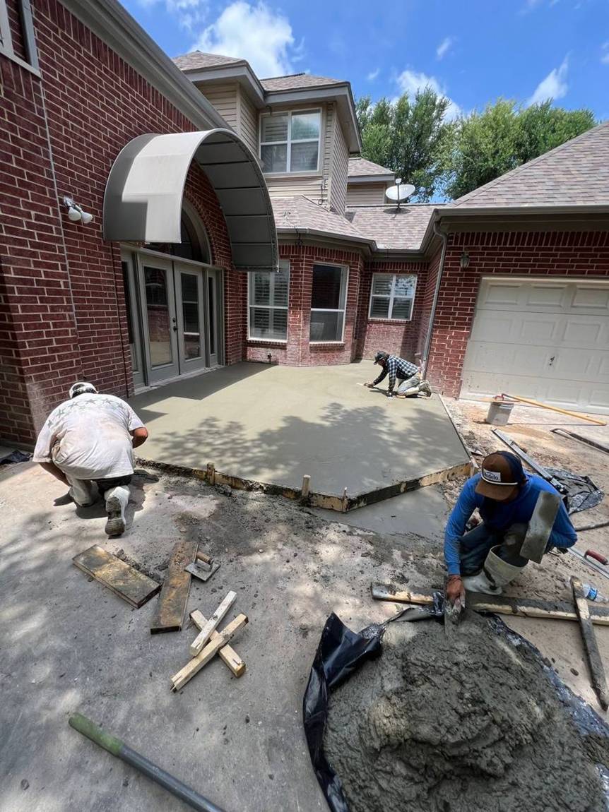 Crew hand-finishing the fresh concrete