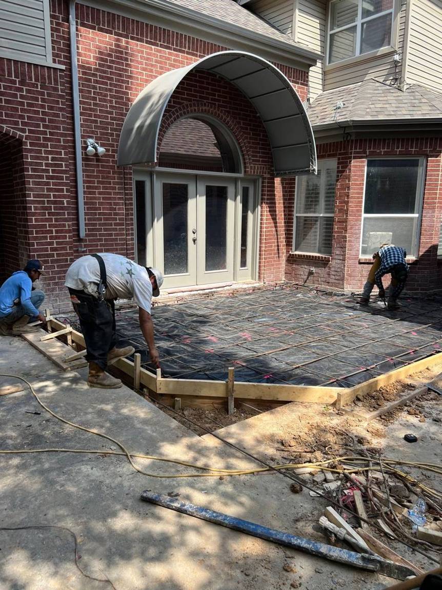 Crew tying the rebar grid over the vapor barrier