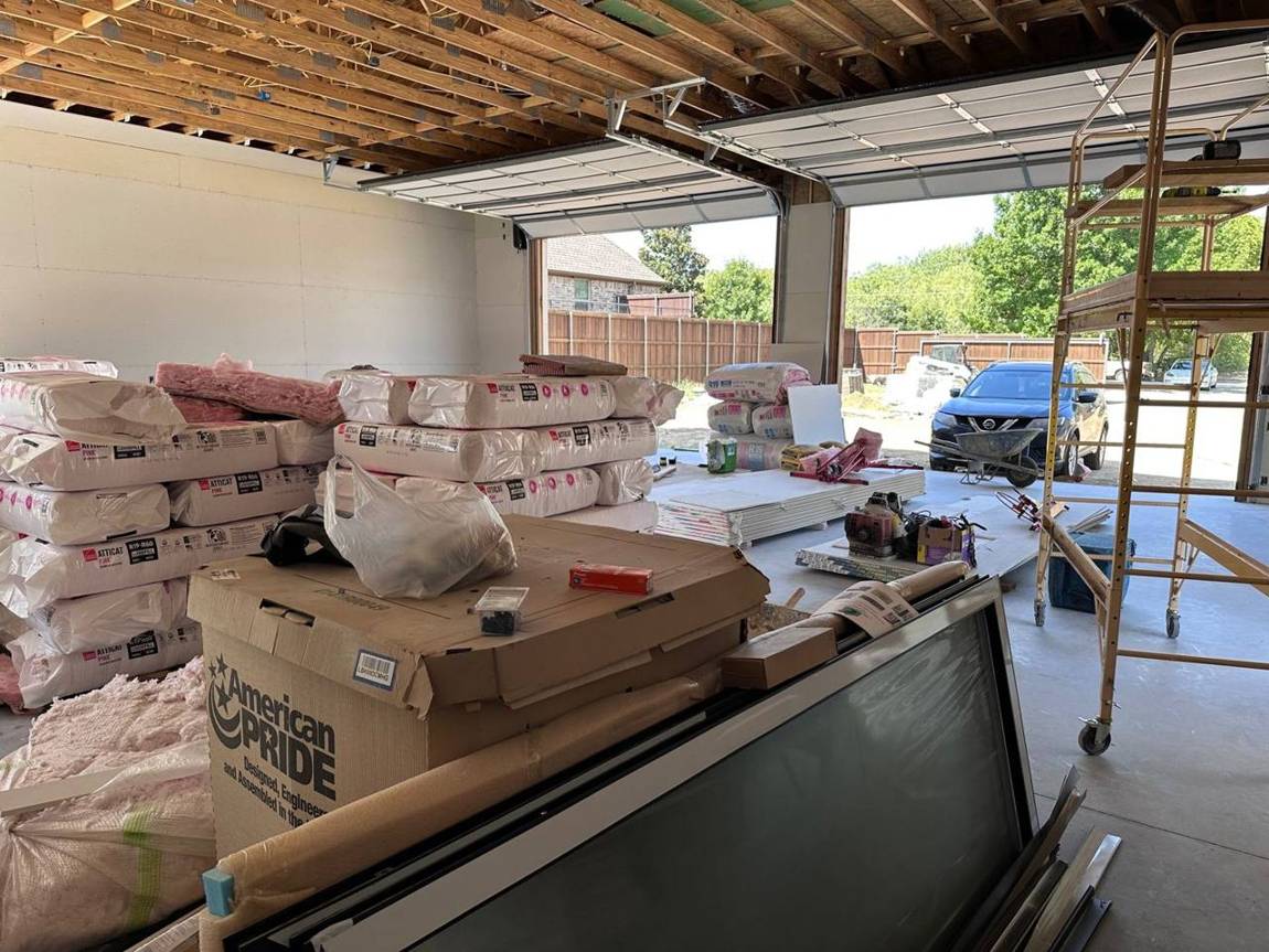 Drywall going up inside with roll-up doors installed