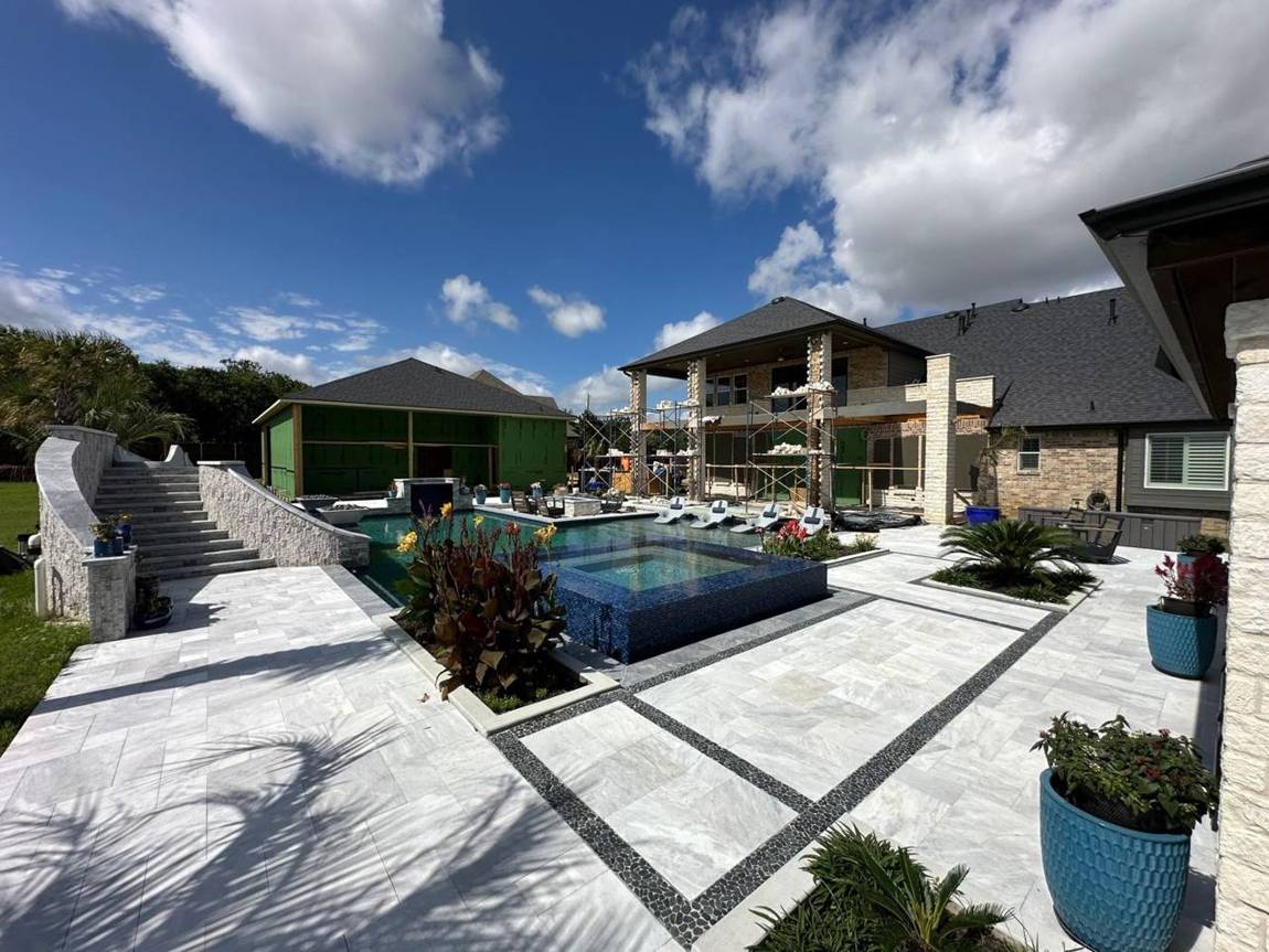 The estate backyard with the pool, the new brick warehouse and the main house patio under construction