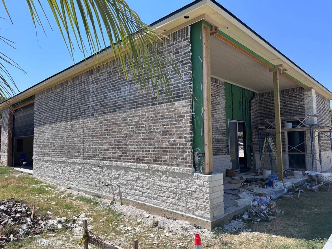 Brick and stone going on the walls and covered porch